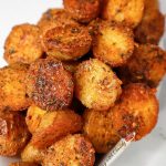 Roasted Garlic Butter Parmesan Potatoes piled in a dish.