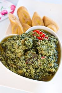 Heart-shaped bowl of Ndole (Peanut Bitterleaf Stew.)