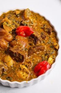 Ogbono Soup topped with bright red Scotch Bonnets.