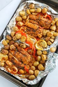 Foil sheets of Baked Fish and vegetables.