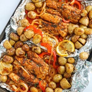 Foil sheets of Baked Fish and vegetables.