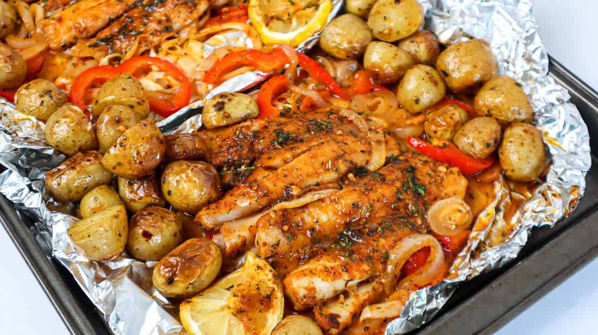Baked fish and vegetables on foil.