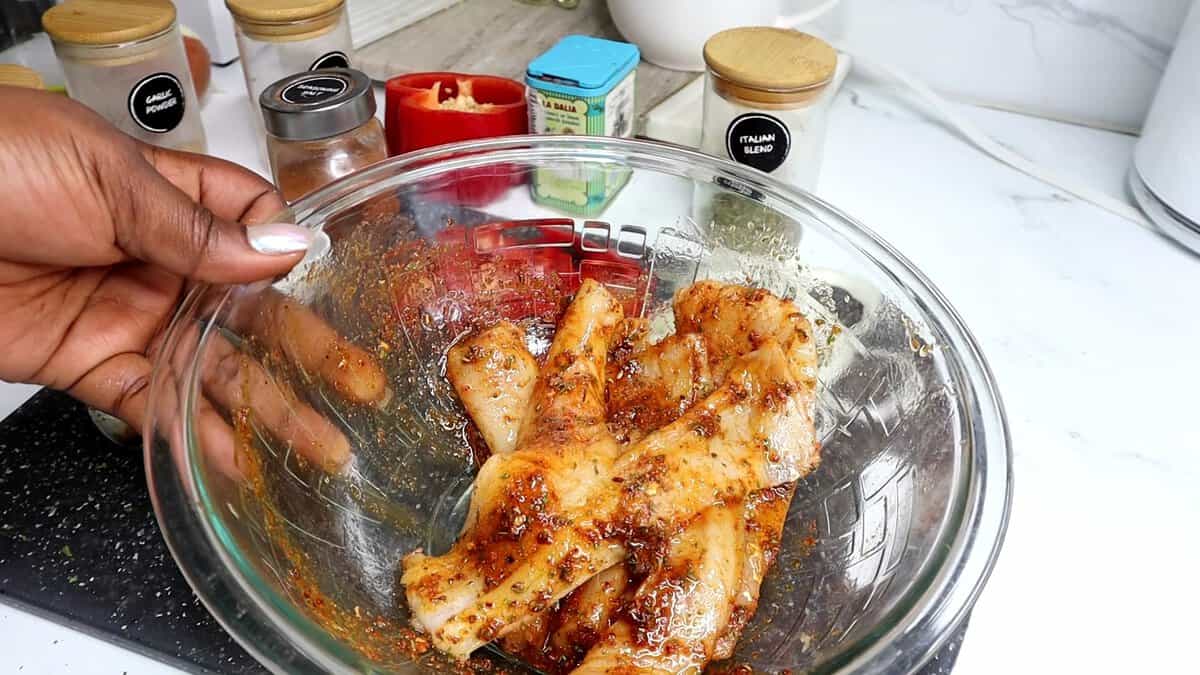 Glass bowl of marinating fish.