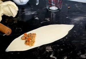 Fish mixture on an oblong piece of dough.