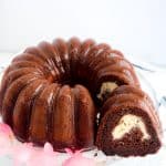 One slice removed from a Chocolate Cream Cheese Bundt Cake.