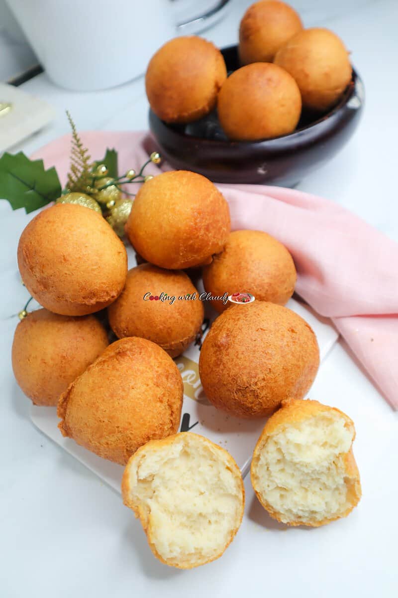 Pile of Crunchy Nigerian Buns, one of which is pulled apart.