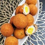 Scotch Eggs on a long, white dish.