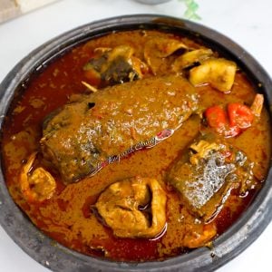 Banga (Palm Nut) Soup in a black bowl.