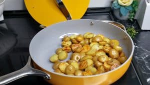 Potatoes in a yellow skillet.