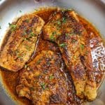 Pan of Pan-Seared Cajun Red Snapper with Cajun Butter Sauce.