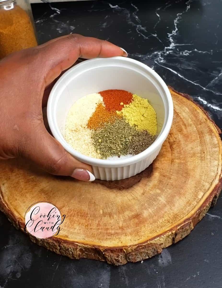 Person holding a bowl of unmixed spices.