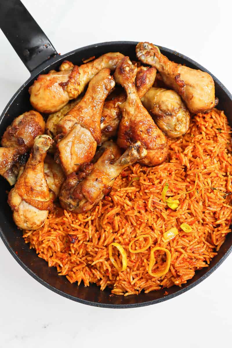 Nigerian Jollof Rice in a pan with chicken.