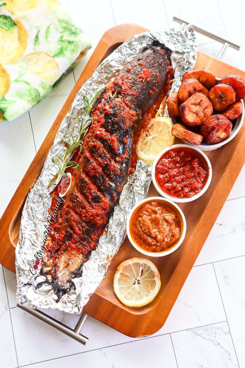 Grilled catfish on foil with sauces.
