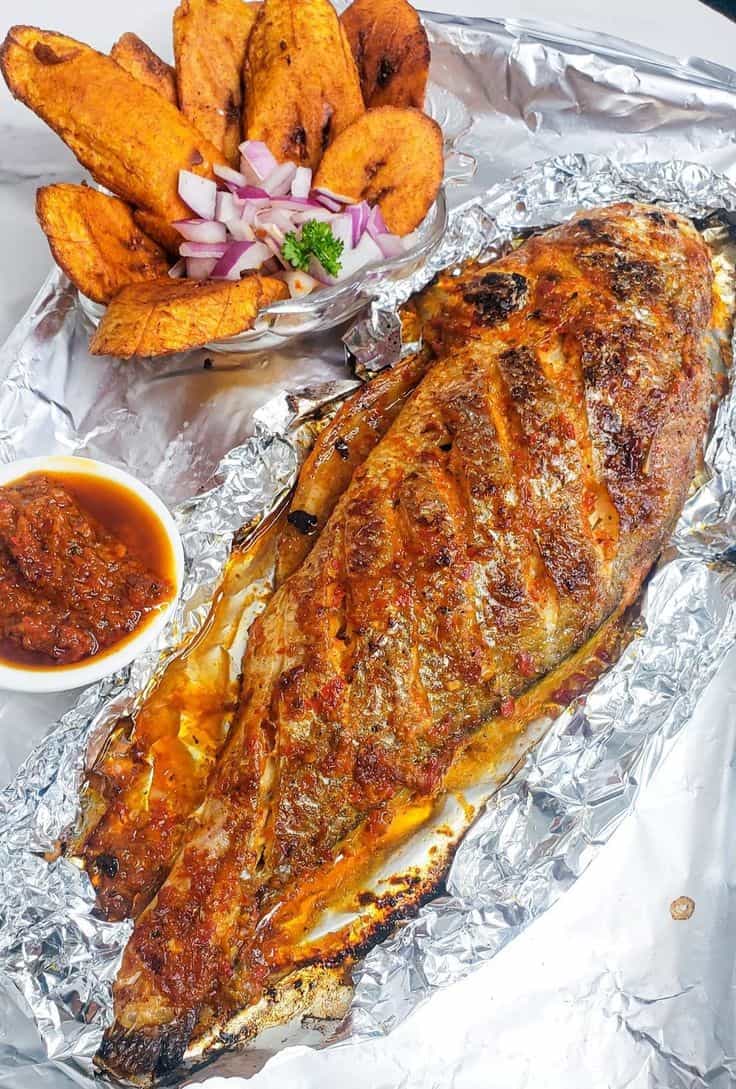 Oven-grilled croaker fish on foil.