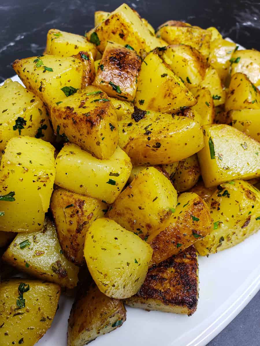 Crispy Garlic Herb Roasted Potatoes on a plate.