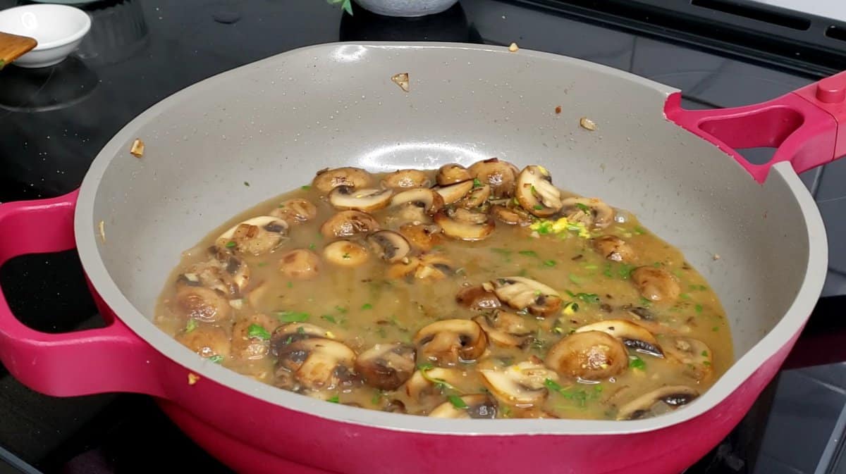 Ingredients cooking in chicken broth.