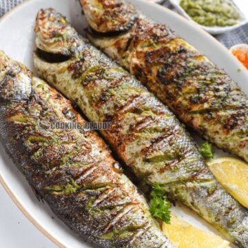 Three Cameroonian Grilled Fish on a plate.