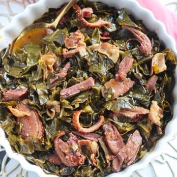 Spoon in a white dish of Southern Collard Greens.