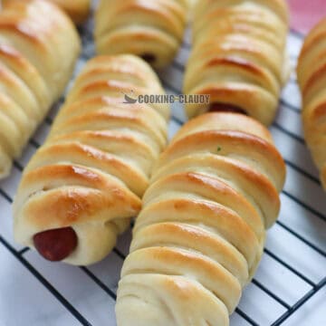 Hot Dog Rolls on a wire rack.