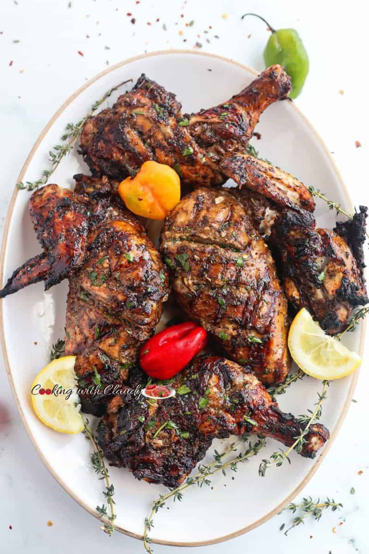 Grilled Jerk chicken with brown char marks on a white plate.