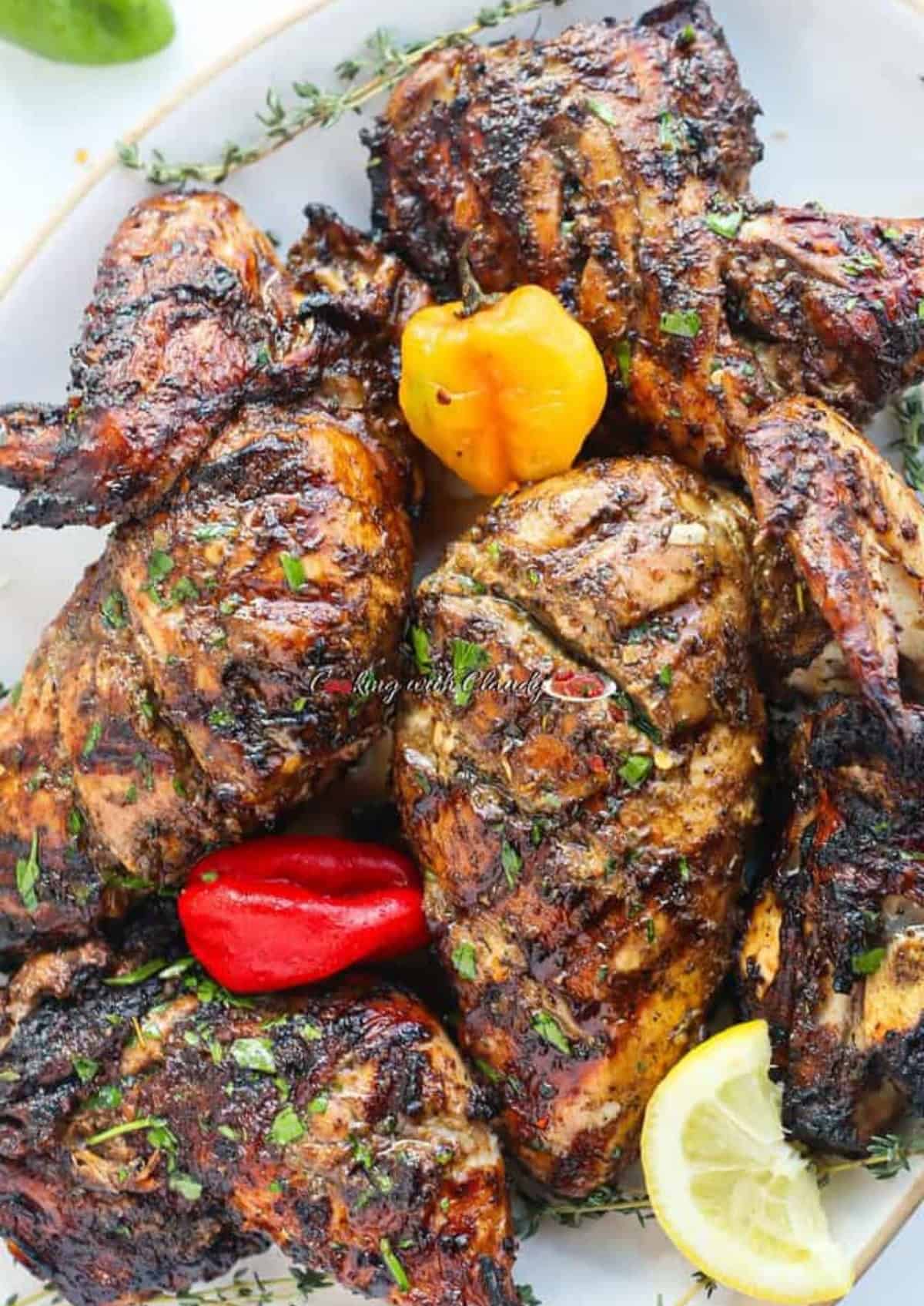 Grilled Jerk chicken with brown char marks on a white plate.