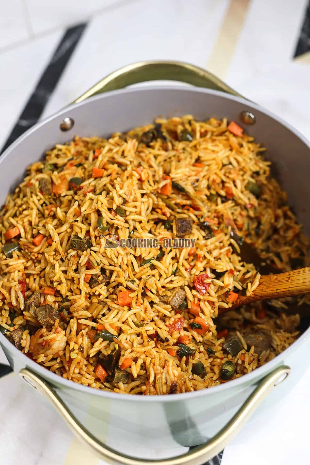 Rice in a pot with a wooden spoon