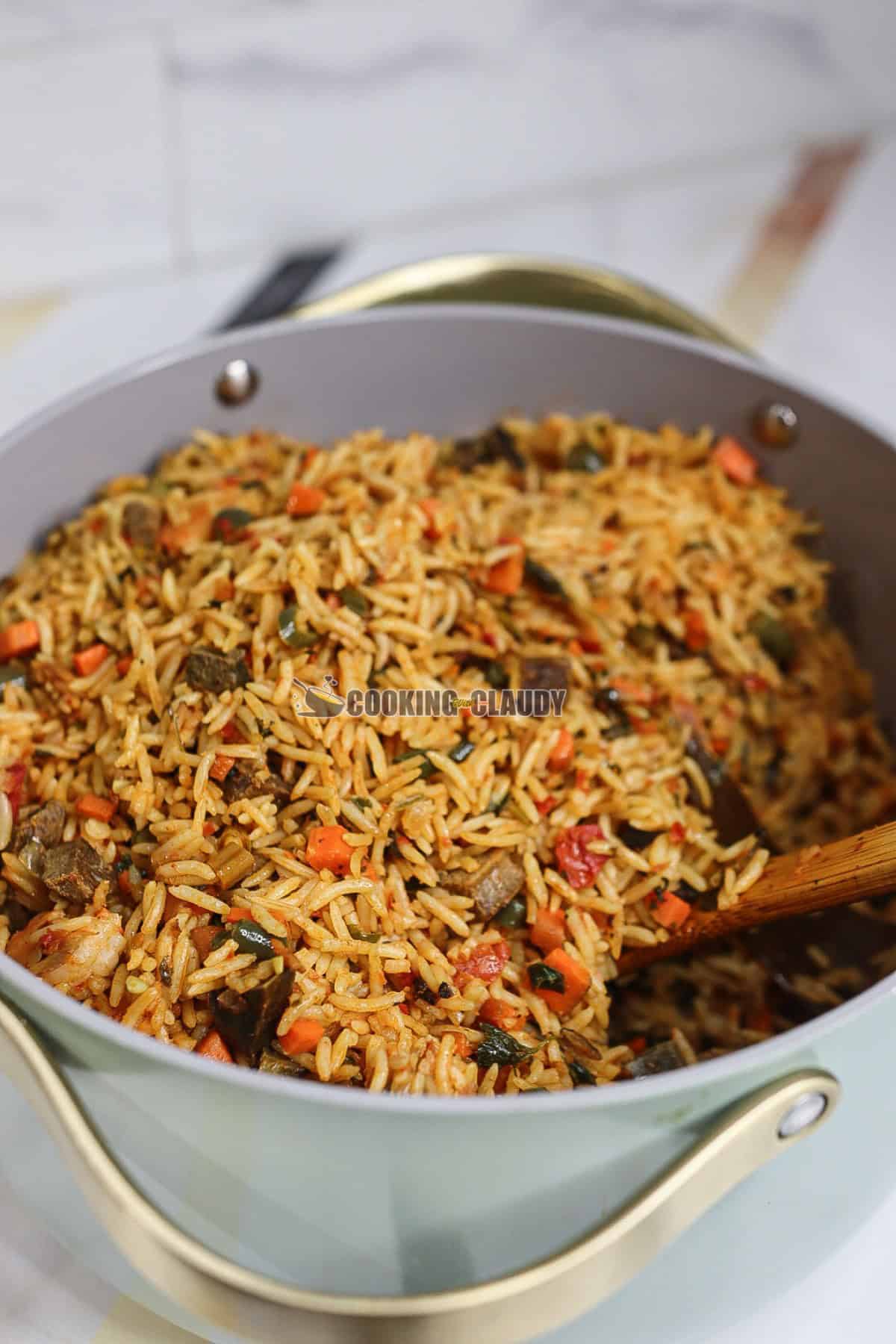 Rice in a pot with a wooden spoon