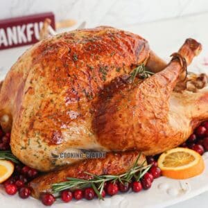 juicy, herb roasted turkey on a plate, served at Thanksgiving.