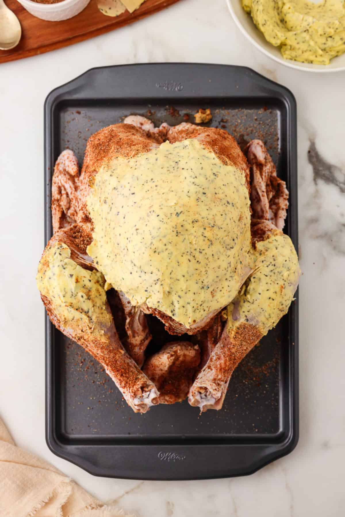 greasing the turkey with herb butter. 