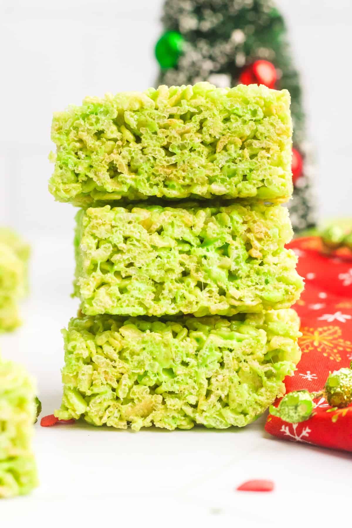 Grinch themed Rice Krispie treats stacked on each other. 