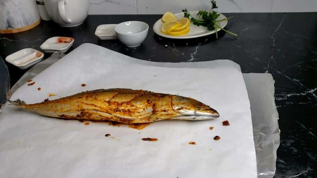 Seasoned mackerel on parchment paper.