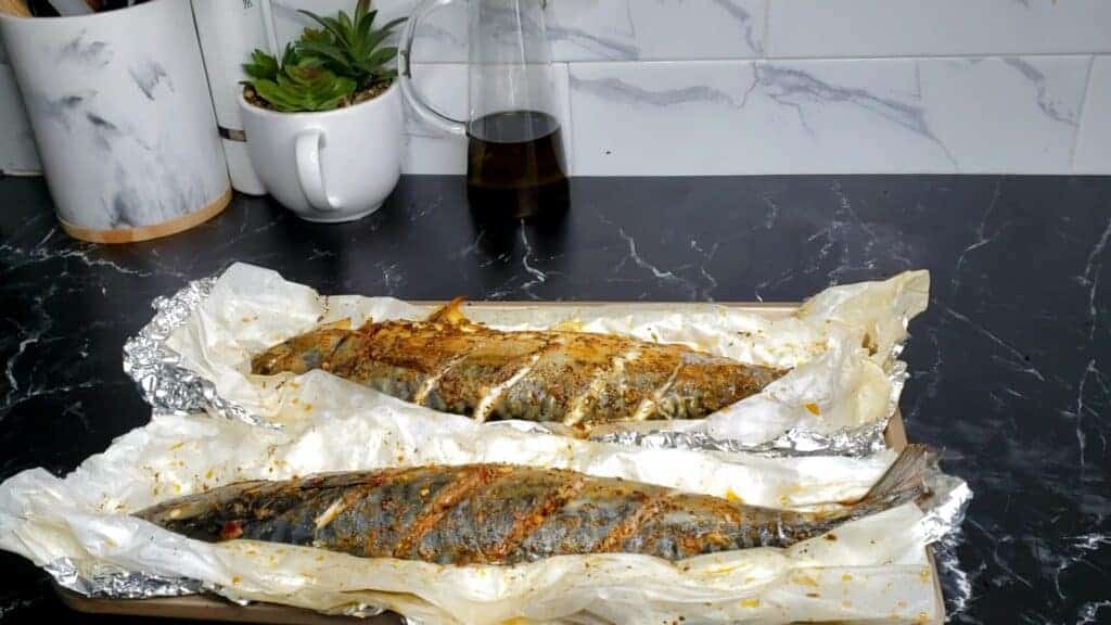 Two Oven-Baked Whole Mackerel on foil.