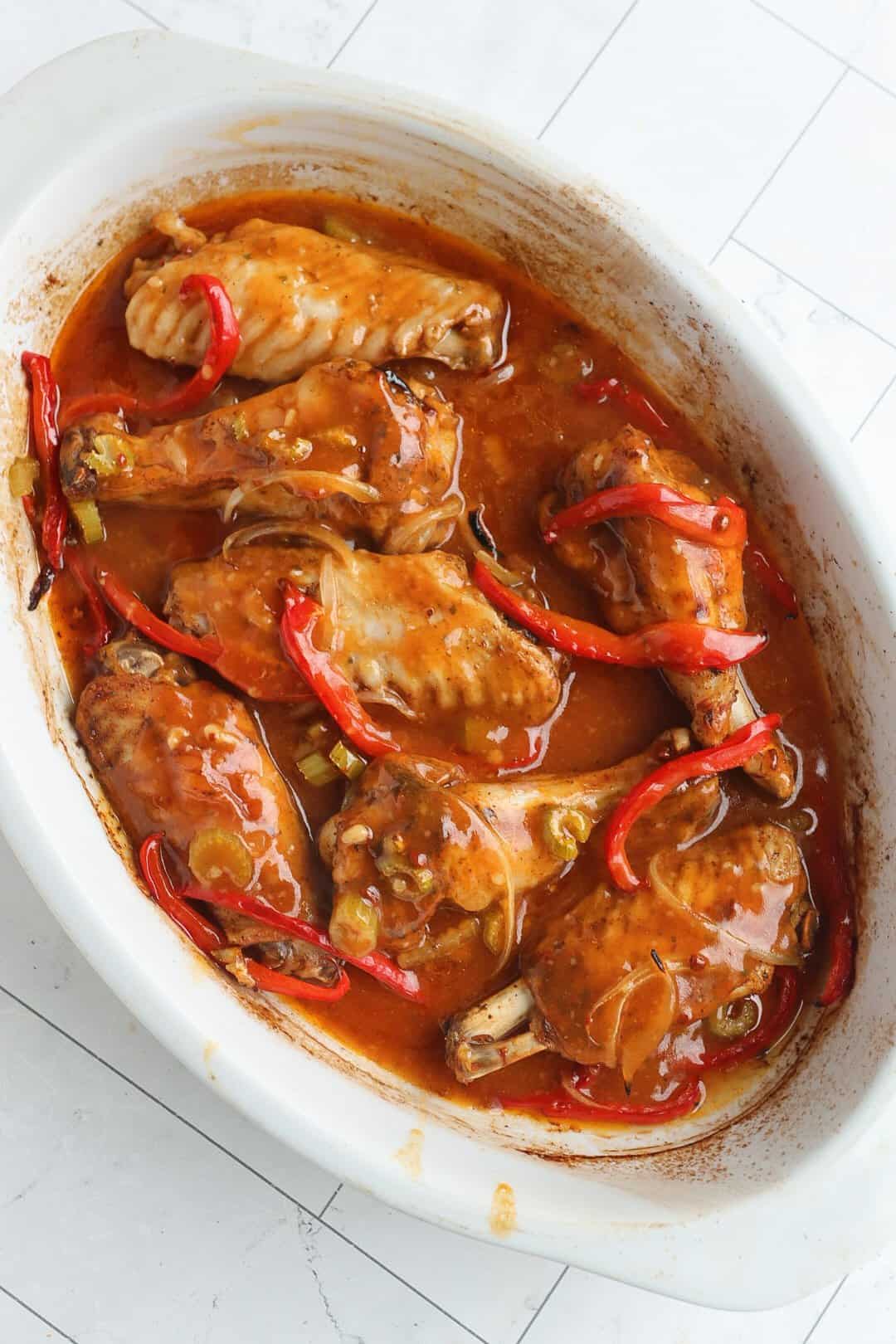 saucy baked turkey wings in a baking dish.