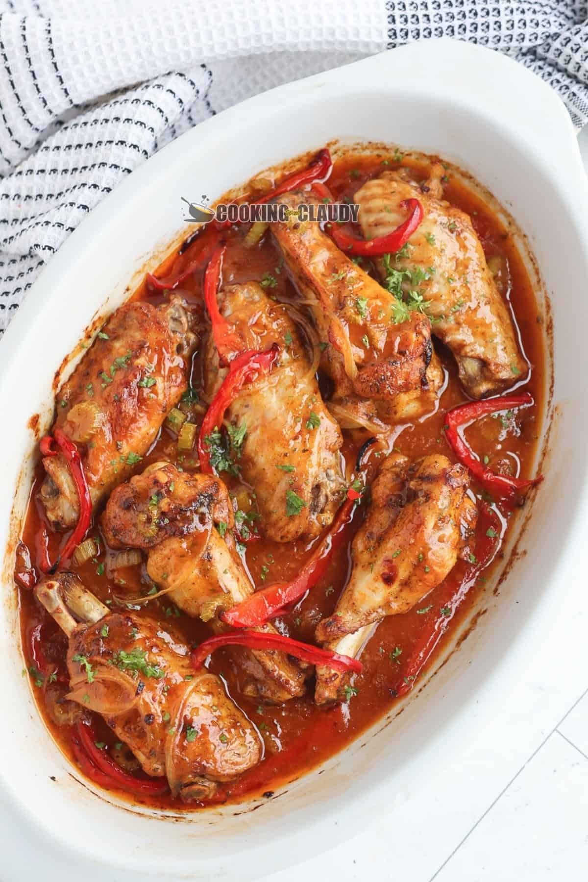 juicy turkey wings in a dish, covered with a spicy sauce. 