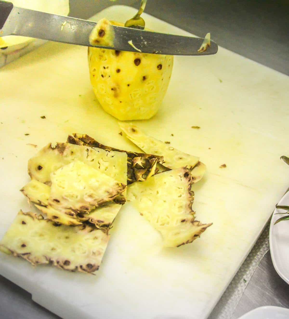 peeled pineapple on a white board