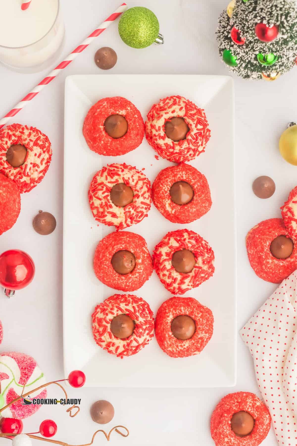 Christmas Blossom cookies with red sprinkles arranged on a serving dish. 