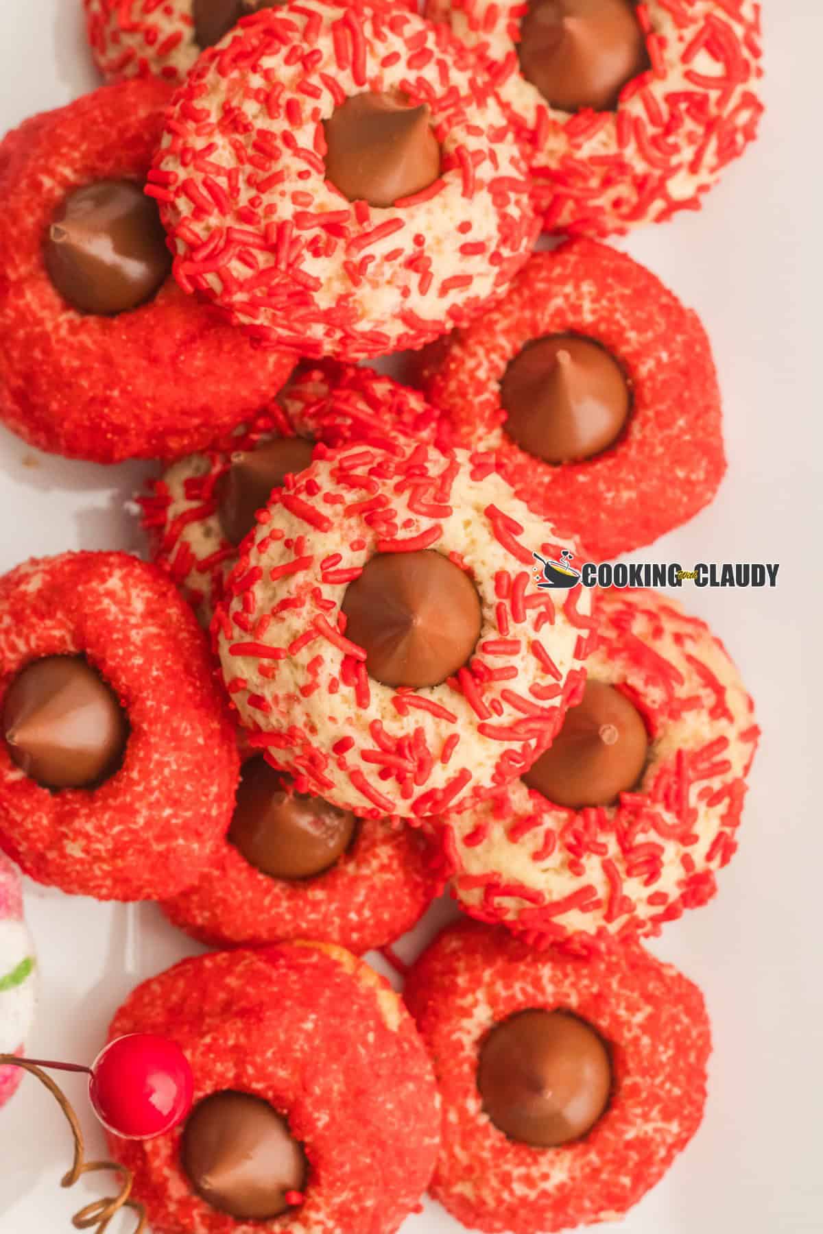 Red colored cookies with a Hershey's Chocolate Kiss in the middle. 