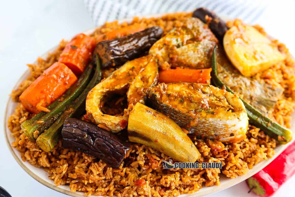 side view of a plate filled with Thieboudienne. 