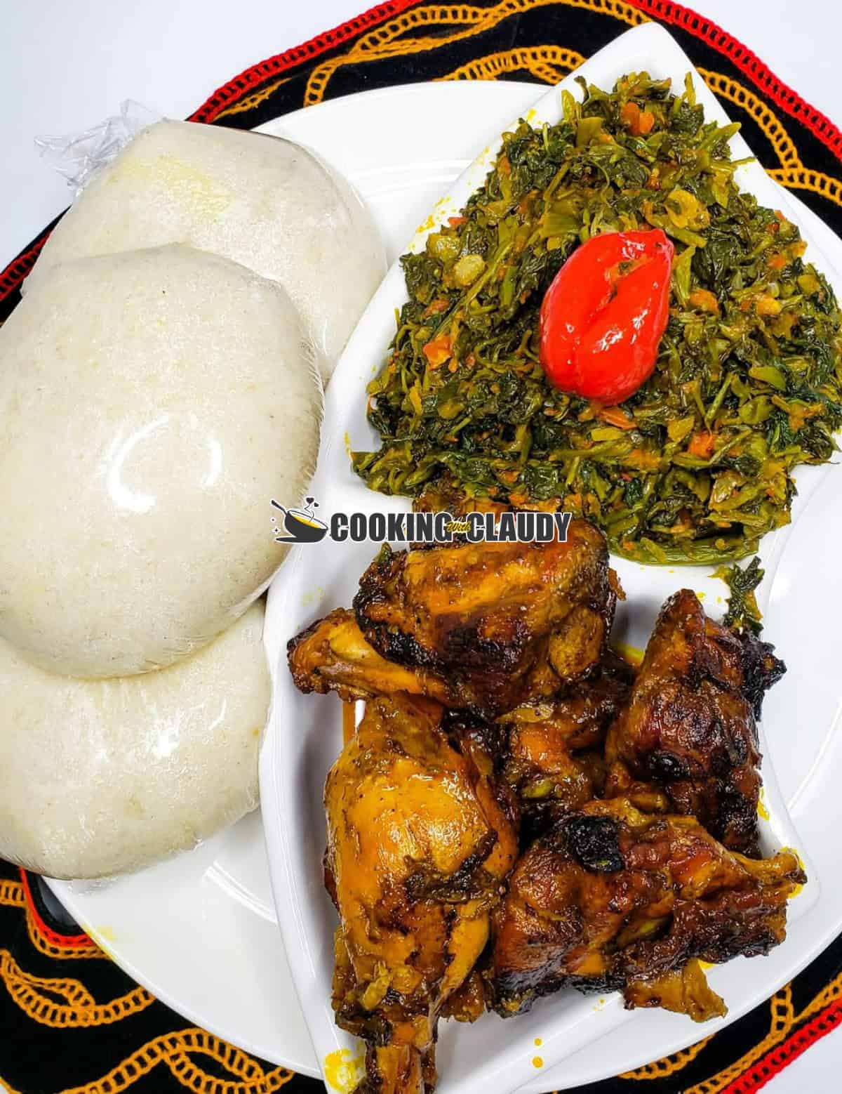 fufu, njama njama and huckle berry in a white plate