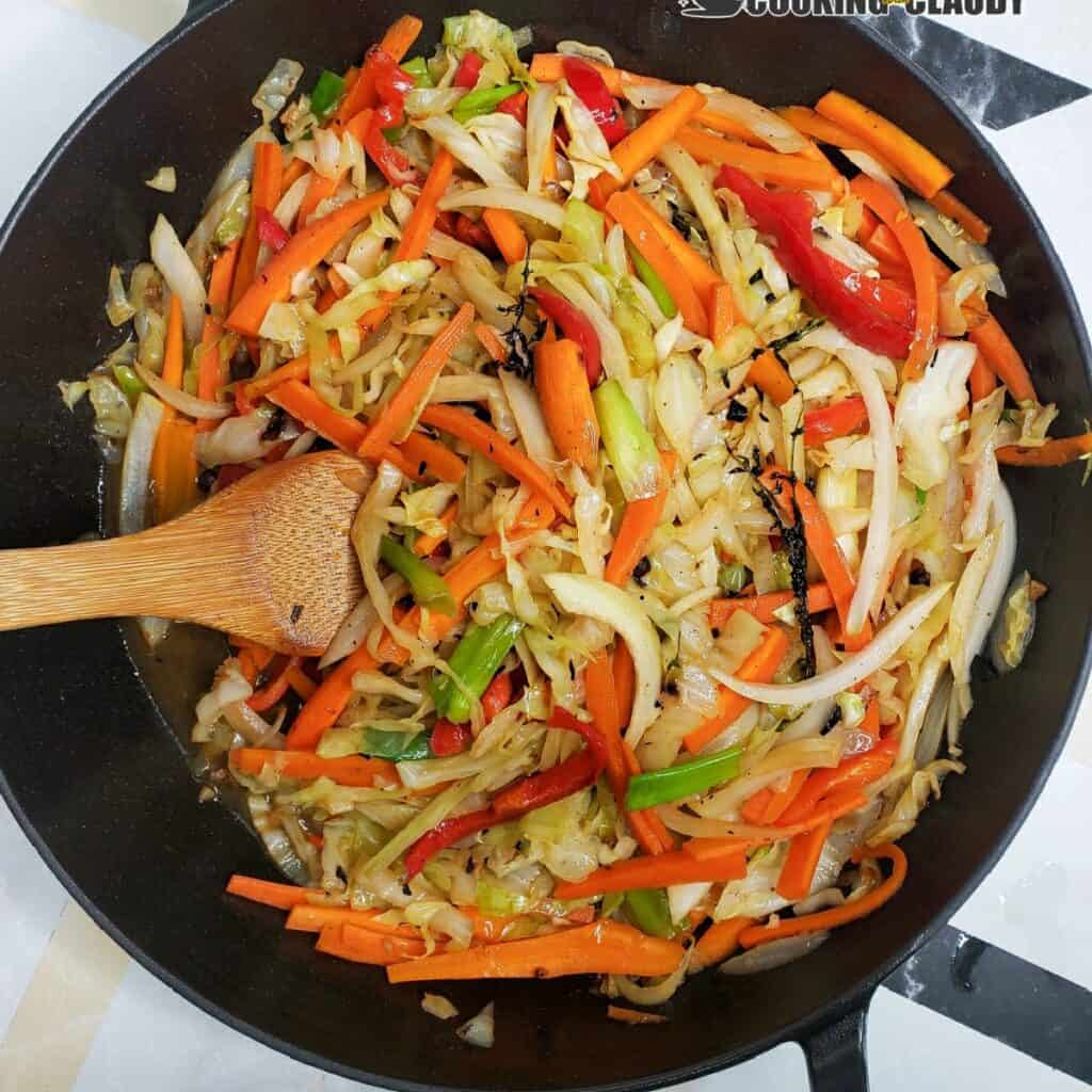 Jamaican steamed cabbage in a black skillet