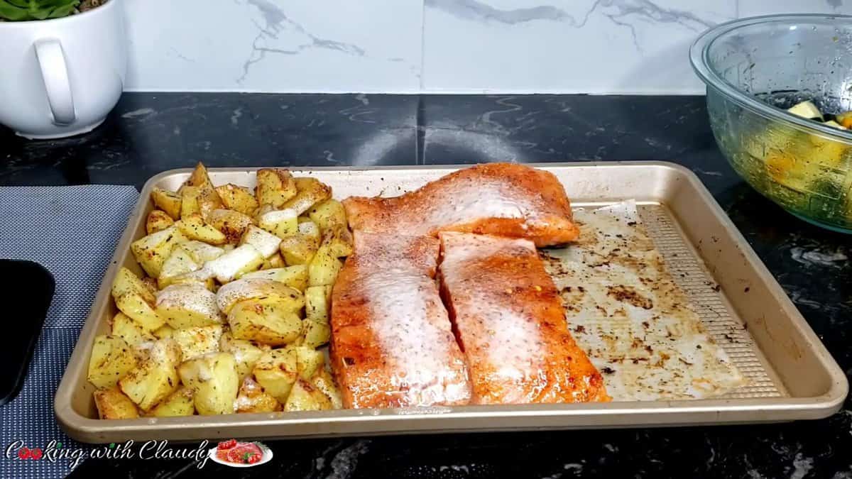 potatoes and salmon on a sheet pan