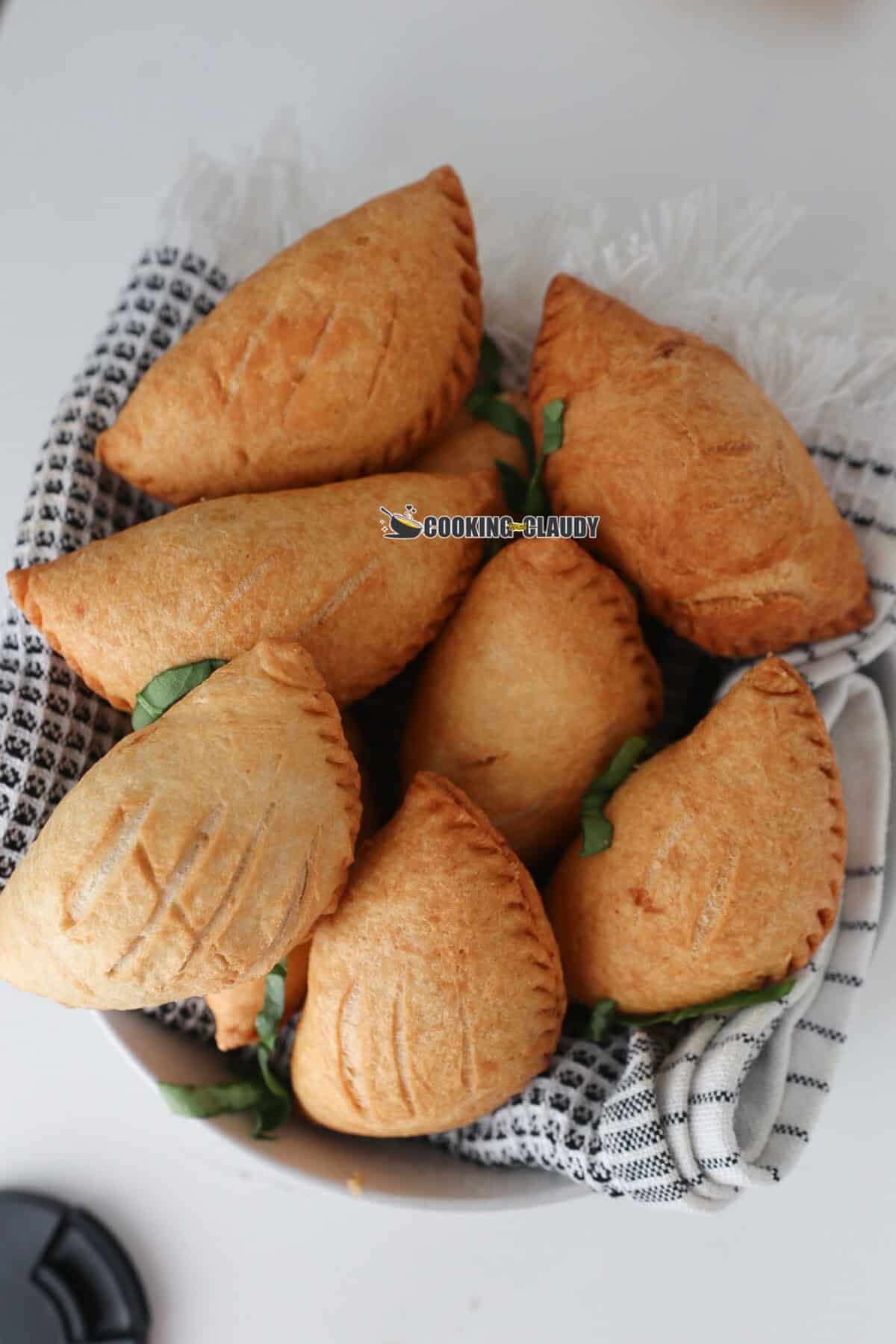 A bowl of meat pie on a table.