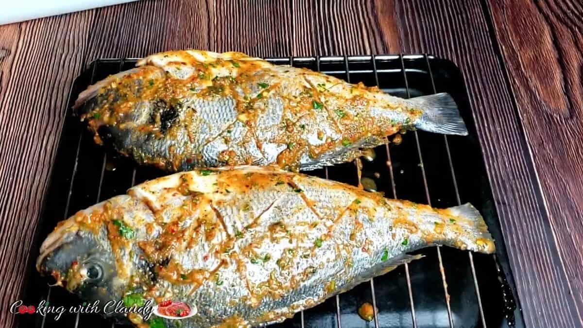 marinated fish on a baking tray