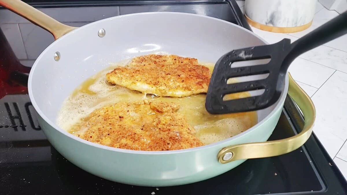 fried fish in a pan with oil