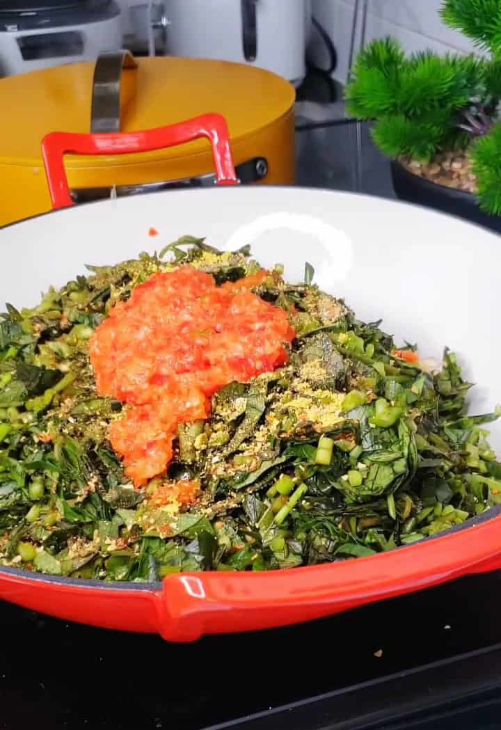 potato leaves in a pot  with onions and peppers