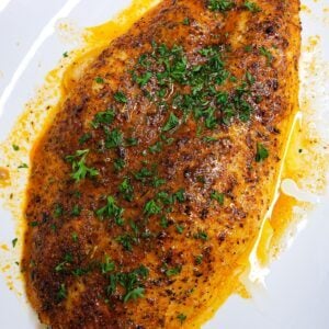 baked basa fish in a white plate