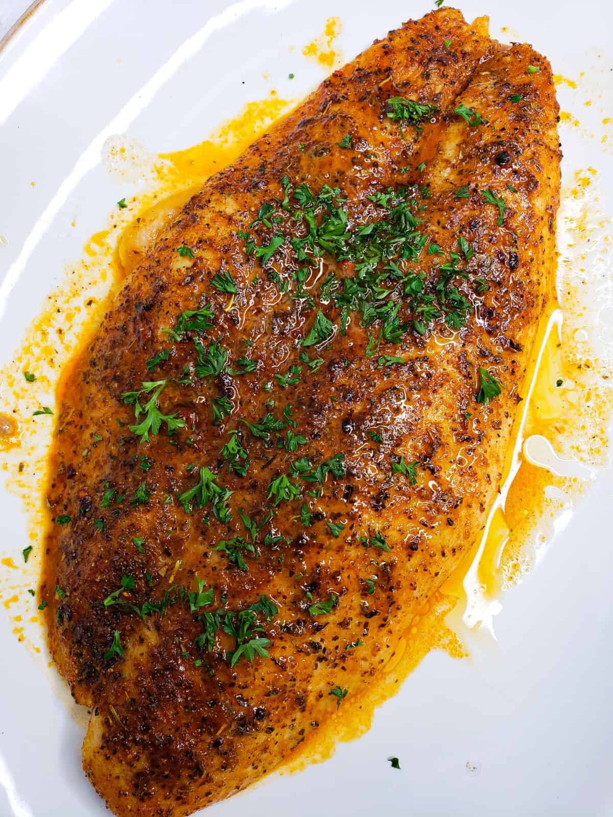 baked basa fish in a white plate
