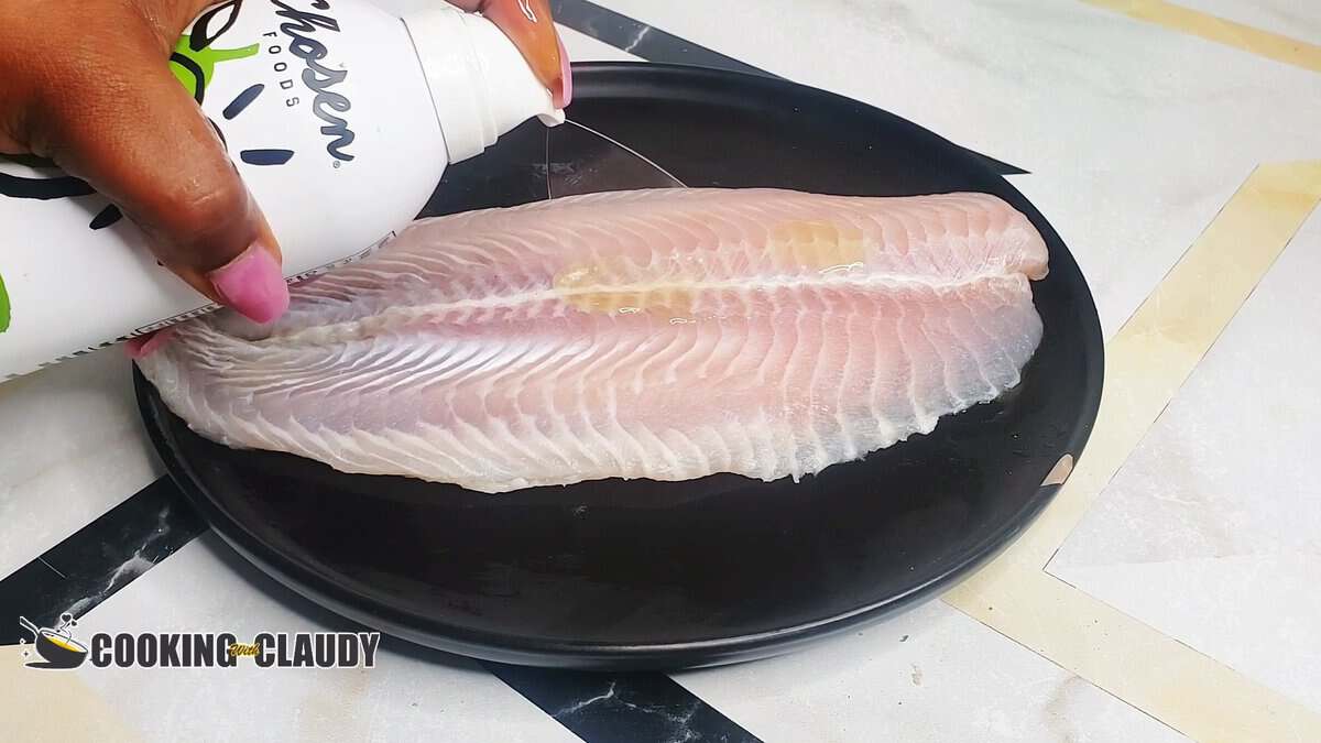 spraying oil on basa fish
