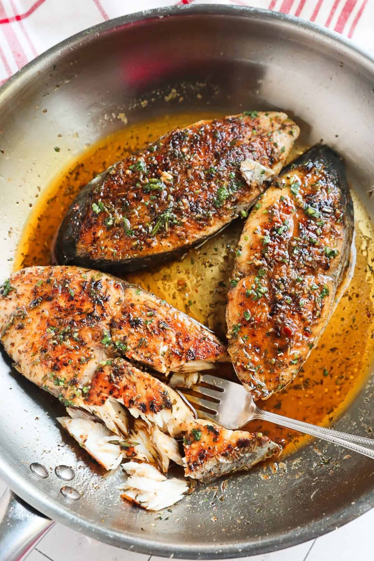 garlic butter fish in a pan