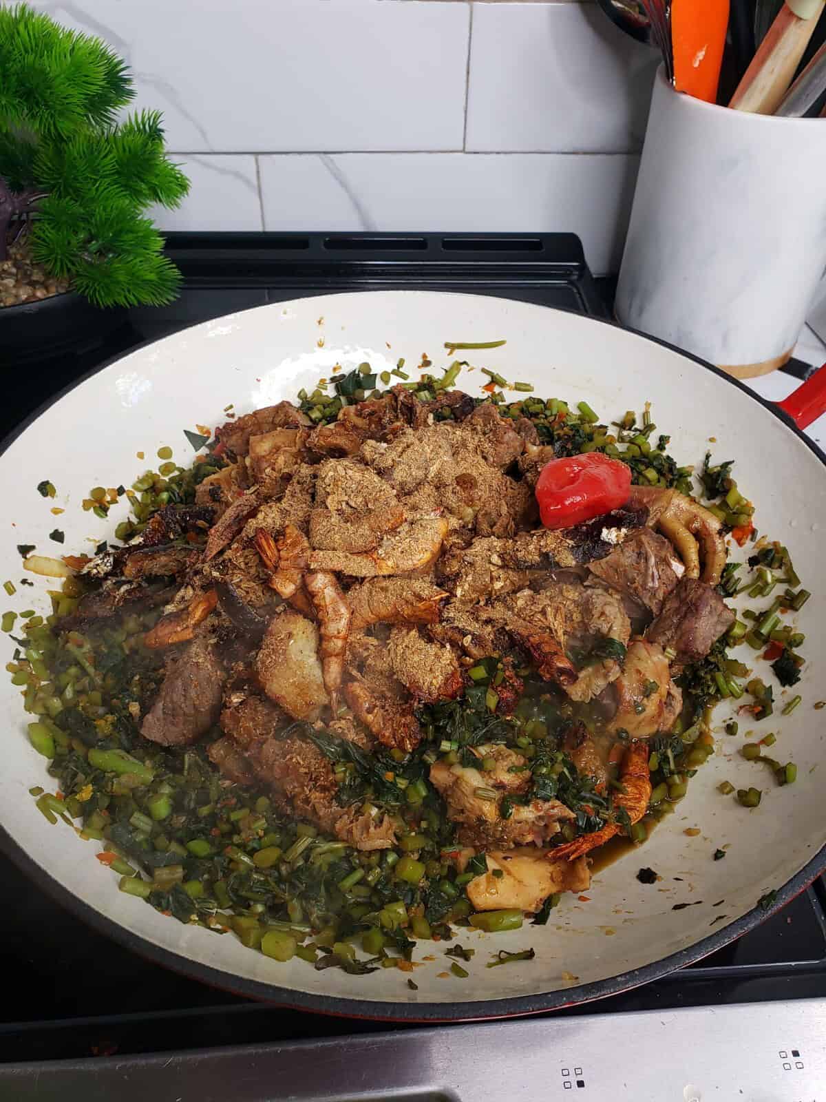 potato leaves in a pot with spices